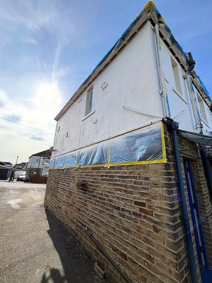 Gable end masked and taped before an exterior spray