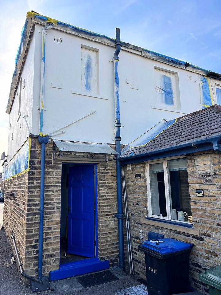 Rendered house masked up for exterior spraying