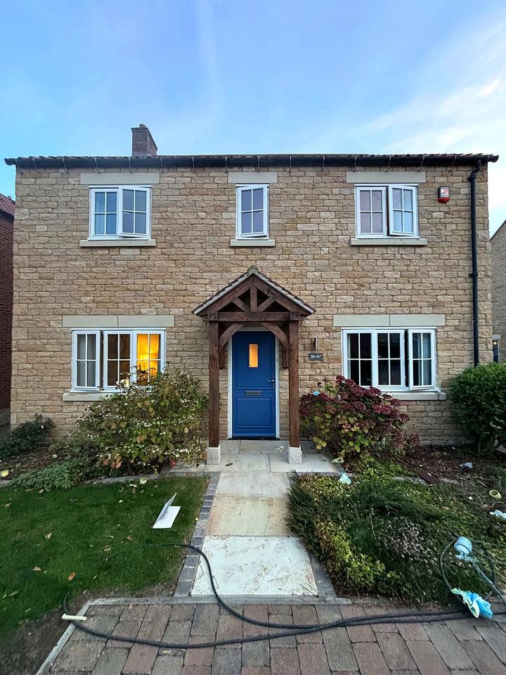 Stone semi-detached house after window respray