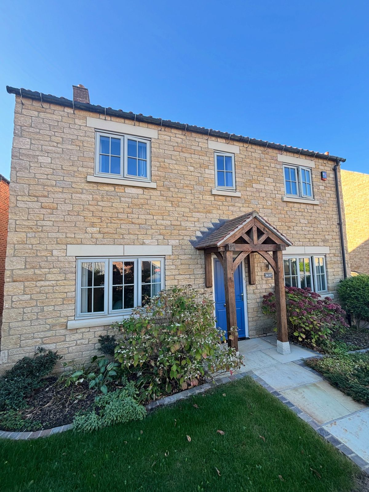 Stone house with its wooden windows resprayed in cream