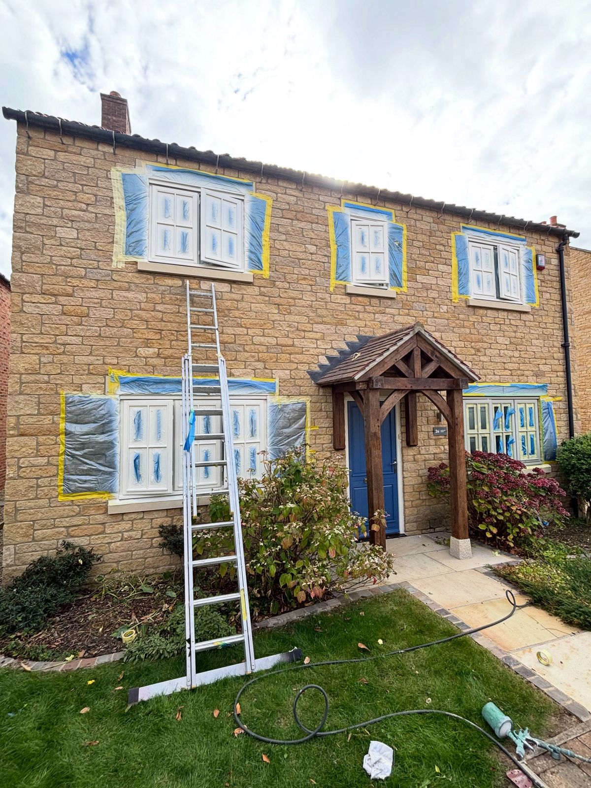 The same house with every window masked, ready to spray